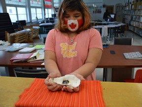 Niji Mahkwa School student Sunny-Rain Campbell prepares to take part in a traditional smudge at the school in Winnipeg's North End on Thursday, Sept. 9, 2021.