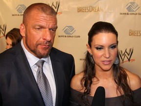 Stephanie McMahon, the WWE's Chief Brand Officer, and her husband WWE COO Triple H, attend Wrestlemania 30 in New Orleans, April 3, 2014.