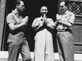 Pierre Trudeau and Jacques Hebert salute a monk in Buddhist fashion in China. From the book Two Innocents in Red China by Pierre Trudeau and Jacques Hebert.