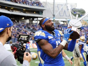 Winnipeg Blue Bombers DE Willie Jefferson hoists the Banjo Bowl trophy after beating the Saskatchewan Roughriders in Winnipeg on Sat., Sept. 11, 2021. The Bombers will look to sweep the September home-and-home for the second straight year after taking last week’s Labour Day Classic in Regina.