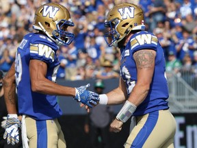 Winnipeg Blue Bombers WR Kenny Lawler (left) congratulates QB Sean McGuire on his touchdown run against the Saskatchewan Roughriders during the Banjo Bowl in Winnipeg on Sat., Sept. 11, 2021. KEVIN KING/Winnipeg Sun/Postmedia Network