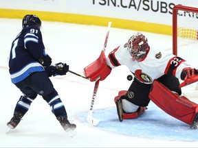 Winnipeg Jets centre Cole Perfetti (left) beats Ottawa Senators goaltender Filip Gustavsson for a shootout goal during NHL exhibition play at Canada Life Centre in Winnipeg on Sun., Sept. 26, 2021. KEVIN KING/Winnipeg Sun/Postmedia Network