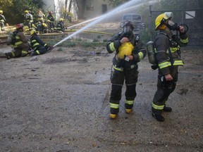 Winnipeg fire fighters battle a blaze in the vicinity of The Louise Bridge, in Winnipeg on Tuesday, Sept. 28, 2021.  Chris Procaylo/Winnipeg Sun