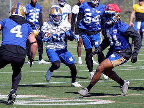 Wide receiver Janarion Grant (centre) returns a punt during Winnipeg Blue Bombers practice on the University of Manitoba campus on Monday.