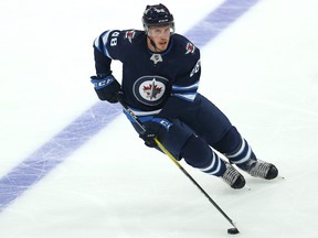 Winnipeg Jets defenceman Nate Schmidt carries the puck against the Edmonton Oilers in Winnipeg on Wednesday, Sept. 29, 2021.