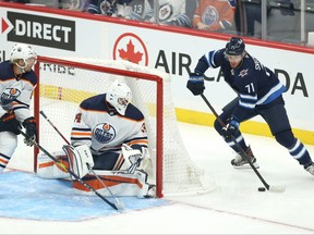 Winnipeg Jets forward Evgeny Svechnikov (right) attempts a wraparound against Edmonton Oilers goaltender Ilya Konovalov in Winnipeg on Wed., Sept. 29, 2021. KEVIN KING/Winnipeg Sun/Postmedia Network