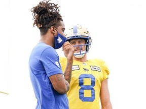 Naaman Roosevelt left) chats with Zach Collaros at Blue Bombers practice on Thursday. The receiver  and the qb knew each other in high school and were teammate with the Roughriders in 2019.
