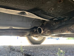 The undercarriage of a vehicle in Winnipeg which has had its catalytic converter stolen.