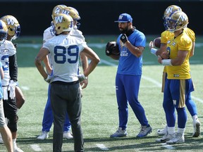Injured slotback Nic Demski, wearing street clothes, hangs out with the offence during Winnipeg Blue Bombers practice at IG Field on Wednesday, Sept. 1, 2021.