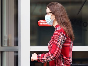 A woman wearing a mask walks in the Exchange District in Winnipeg on Thurs., Sept. 2, 2021. KEVIN KING/Winnipeg Sun/Postmedia Network