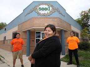 Money Stories facilitators Justin Huntinghawk, Calandra Necan, and Andrew Proulx-Courchesne (from left) pose in front of the SEED Winnipeg office on Salter Street on Thursday, Sept. 2, 2021.