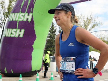 Nicole Walker, the top female finisher at the Manitoba Marathon, catches her breath in the finish area on Chancellor Matheson in Winnipeg on Sunday, Sept. 5, 2021.