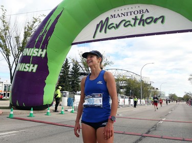 Nicole Walker, the top female finisher at the Manitoba Marathon, stops in the finish area on Chancellor Matheson in Winnipeg on Sunday, Sept. 5, 2021.