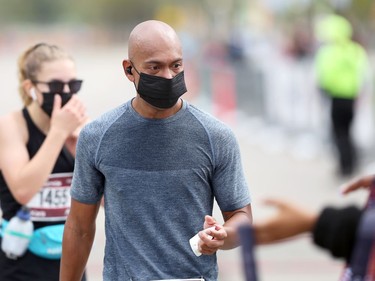 Orlando de Ala collects his finisher medal after running the half marathon at the Manitoba Marathon in Winnipeg on Sunday, Sept. 5, 2021.