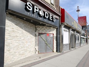 Police tape remains on the door at Spades Lounge and Hookah Bar on Portage Avenue in Winnipeg on Mon., Sept. 6, 2021 after an apparent shooting early Saturday morning. KEVIN KING/Winnipeg Sun/Postmedia Network