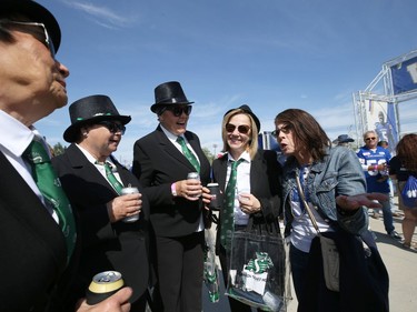 A Winnipeg Blue Bombers fan (right) is hoping these Saskatchewan Roughriders fans in the tailgate area will be singing the blues after the Banjo Bowl in Winnipeg on Saturday, Sept. 11, 2021.