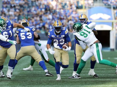 Winnipeg Blue Bombers RB Andrew Harris finds a hole against the Saskatchewan Roughriders during the Banjo Bowl in Winnipeg on Saturday, Sept. 11, 2021.