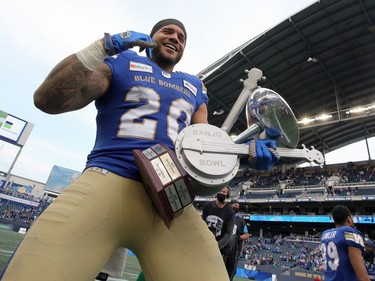 Winnipeg Blue Bombers RB Brady Oliveira plays a tune on the Banjo Bowl trophy after beating the Saskatchewan Roughriders in Winnipeg on Saturday, Sept. 11, 2021.