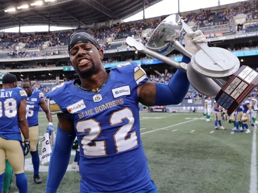 Winnipeg Blue Bombers DB Alden Darby celebrates with the Banjo Bowl trophy after beating the Saskatchewan Roughriders in Winnipeg on Saturday, Sept. 11, 2021.