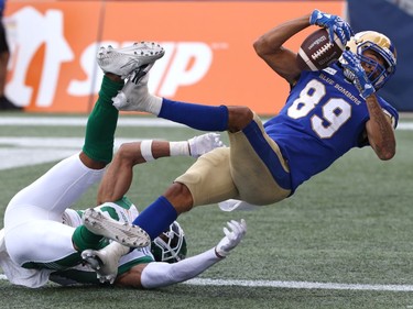 Winnipeg Blue Bombers WR Kenny Lawler (right) falls back into the end zone with a touchdown catch with Saskatchewan Roughriders DB Christian Campbell defending during the Banjo Bowl in Winnipeg on Saturday, Sept. 11, 2021.