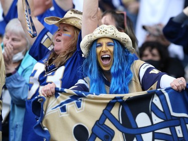 A Winnipeg Blue Bombers fan celebrates a win in the Banjo Bowl over the Saskatchewan Roughriders in Winnipeg on Saturday, Sept. 11, 2021.