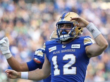 Winnipeg Blue Bombers QB Sean McGuire celebrates his second touchdown run against the Saskatchewan Roughriders during the Banjo Bowl in Winnipeg on Saturday, Sept. 11, 2021.