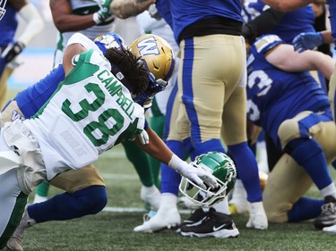Winnipeg Blue Bombers RB Andrew Harris (right) throws Saskatchewan Roughriders DB Christian Campbell to the ground by the helmet during a fracas at the Banjo Bowl in Winnipeg on Saturday, Sept. 11, 2021.
