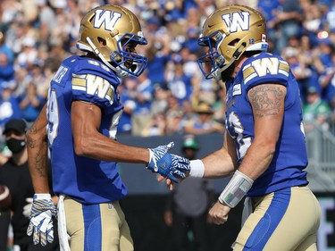 Winnipeg Blue Bombers WR Kenny Lawler (left) congratulates QB Sean McGuire on his touchdown run against the Saskatchewan Roughriders during the Banjo Bowl in Winnipeg on Saturday, Sept. 11, 2021.