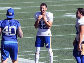 Kickers Ali Mourtada (centre) and Marc Liegghio (right) share a laugh with long snapper Mike Benson during Winnipeg Blue Bombers practice in Winnipeg on Tuesday, Sept. 14, 2021.