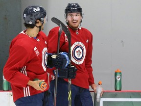 Dylan Samberg (right) and Johnathan Kovacevic speak  during a break at Winnipeg Jets pro minicamp at Bell MTS Iceplex in west Winnipeg on Wednesday, Sept. 16, 2021.