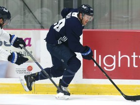 Riley Nash (right) carries the puck with Blake Wheeler in pursuit as some Winnipeg Jets veterans skated at Bell MTS Iceplex in west Winnipeg on Wednesday, Sept. 16, 2021.