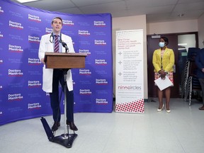 Doctors Manitoba president Kristjan Thompson (left) speaks during a press conference dealing with vaccine hesitancy, at Nine Circles Community Health Centre on Broadway in Winnipeg, on Tues., Sept. 21, 2021. At right are Health Minister Audrey Gordon and Premier Kelvin Goertzen. KEVIN KING/Winnipeg Sun/Postmedia Network