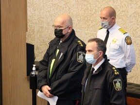 Winnipeg Police Chief Danny Smyth and deputy Chief Art Stannard, along with Winnipeg Fire Paramedic Service Chief Christian Schmidt, wait in council chambers on Friday as elected officials determine the fate of required funding for emergency services.