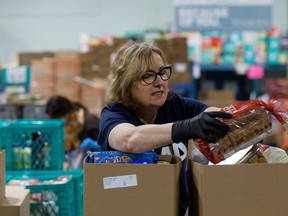 A volunteer packs hampers at the Edmonton Food Bank. A team from the University of Manitoba, Edmonton Food Bank and Baranowski & Sons Nutrition make up one of five winning teams to receive $30,000 US from the Danone Institute North America "One Planet. One Health" Initiative, a grant program that promotes resilient and sustainable local food systems.