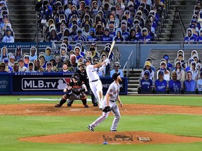 LOS ANGELES, CALIFORNIA - JULY 23: Enrique Hernandez #14 of the Los Angeles Dodgers hits a two run homerun off of Conner Menez #51 of the San Francisco Giants, to take an 8-1 lead during the eighth inning, on MLB Opening Day at Dodger Stadium on July 23, 2020 in Los Angeles, California. The 2020 season had been postponed since March due to the COVID-19 Pandemic.