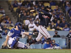 Eddie Rosario #8 of the Atlanta Braves hits a three run home run during the ninth inning of Game Four of the National League Championship Series against the Los Angeles Dodgersat Dodger Stadium on October 20, 2021 in Los Angeles, California.