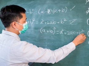 An illustration showing a teacher at a blackboard