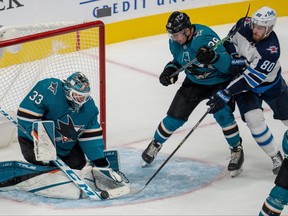 San Jose Sharks goaltender Adin Hill (33) makes a save against Winnipeg Jets center Pierre-Luc Dubois (80) during the third period at SAP Center at San Jose on Oct. 16, 2021.