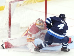 Jets defenceman Neal Pionk is unable to convert a chance in close on Calgary Flames goaltender Daniel Vladar during pre-season action last night in Winnipeg.