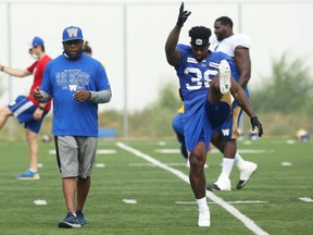 Defensive back Alden Darby (right) speaks with position coach Jordan Younger while stretching during Winnipeg Blue Bombers practice on the University of Manitoba campus in Winnipeg on Wed., July 21, 2021. KEVIN KING/Winnipeg Sun/Postmedia Network