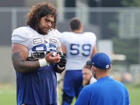 Offensive lineman Asotui Eli, who goes by Tui, has a trainer help with a cut finger during Winnipeg Blue Bombers practice on the University of Manitoba campus in Winnipeg on Thurs., July 22, 2021. KEVIN KING/Winnipeg Sun/Postmedia Network