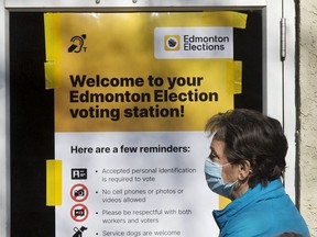 Edmontonians wait for the the advance polling station at the Hazeldean Community League, 9630 66 Avenue, to open in Edmonton, Monday Oct. 4, 2021. As well as the municipal election, residents across Alberta will also be voting on two referendum questions regarding equalization and year-round Daylight Saving Time, and a Senate election.