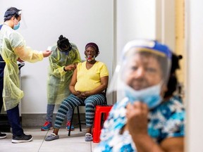 Doctor Meera Jayarajan and nurse Kevin Sagun from Humber River Hospital administer the Moderna coronavirus disease (COVID-19) vaccine to residents at a Toronto Community Housing seniors building in the northwest end of Toronto, Ontario, Canada March 25, 2021.