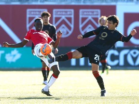 Cavalry FC’s Victor Loturi and Valour FC’s Jose Galan compete for the ball at ATCO Field at Spruce Meadows on Saturday, Oct. 30, 2021.