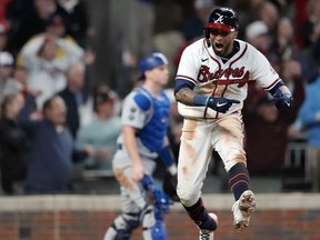 Atlanta Braves left fielder Eddie Rosario (8) celebrates his walk off game winning RBI against the Los Angeles Dodgers  during the ninth inning in game two of the 2021 NLCS at Truist Park. Brett Davis-USA TODAY Sports