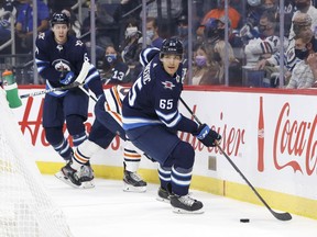 Winnipeg Jets defenceman Johnathan Kovacevic (65) skates the puck behind the net against the Edmonton Oilers in the first period at Canada Life Centre in Winnipeg on Wednesday, Sept. 29, 2021.