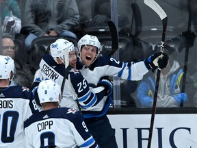 Oct 26, 2021; Anaheim, California, USA; Winnipeg Jets left wing Nikolaj Ehlers (27) celebrates with Winnipeg Jets center Paul Stastny (25) after scoring a goal to tie the game in the third period against the Anaheim Ducks at Honda Center. Mandatory Credit: Jayne Kamin-Oncea-USA TODAY Sports
