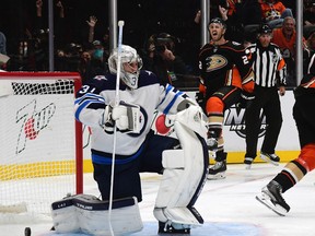 Oct 13, 2021; Anaheim, California, USA; Anaheim Ducks defenseman Kevin Shattenkirk (22) celebrates his goal scored against Winnipeg Jets goaltender Connor Hellebuyck (37) during the first period at Honda Center. Mandatory Credit: Gary A. Vasquez-USA TODAY Sports