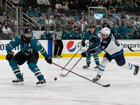 San Jose Sharks defencceman Brent Burns (88) attempts to defend against Winnipeg Jets center Andrew Copp (9) during the third period at SAP Center at San Jose on Saturday, Oct. 30, 2021.