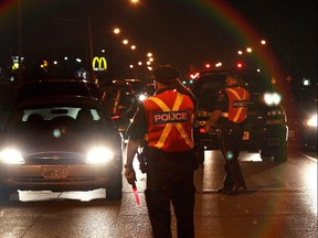 Police officers stop drivers near Windsor Raceway on August 14, 2010 during a RIDE program in Windsor, Ont.